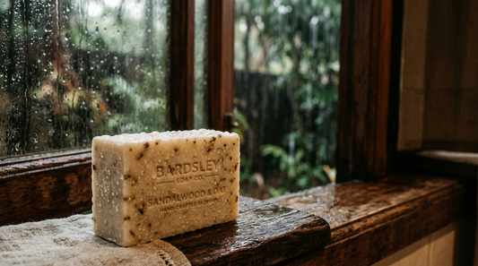 Soap bar covered in fine beads of moisture with monsoon rain visible through a window